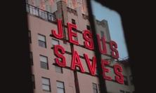 Photo of neon sign reading 'Jesus Saves'