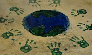 Handprints around a globe